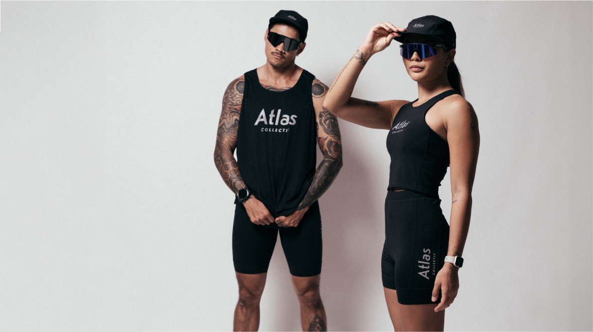 Two people wearing black 'Atlas' branded suits on a plain background
