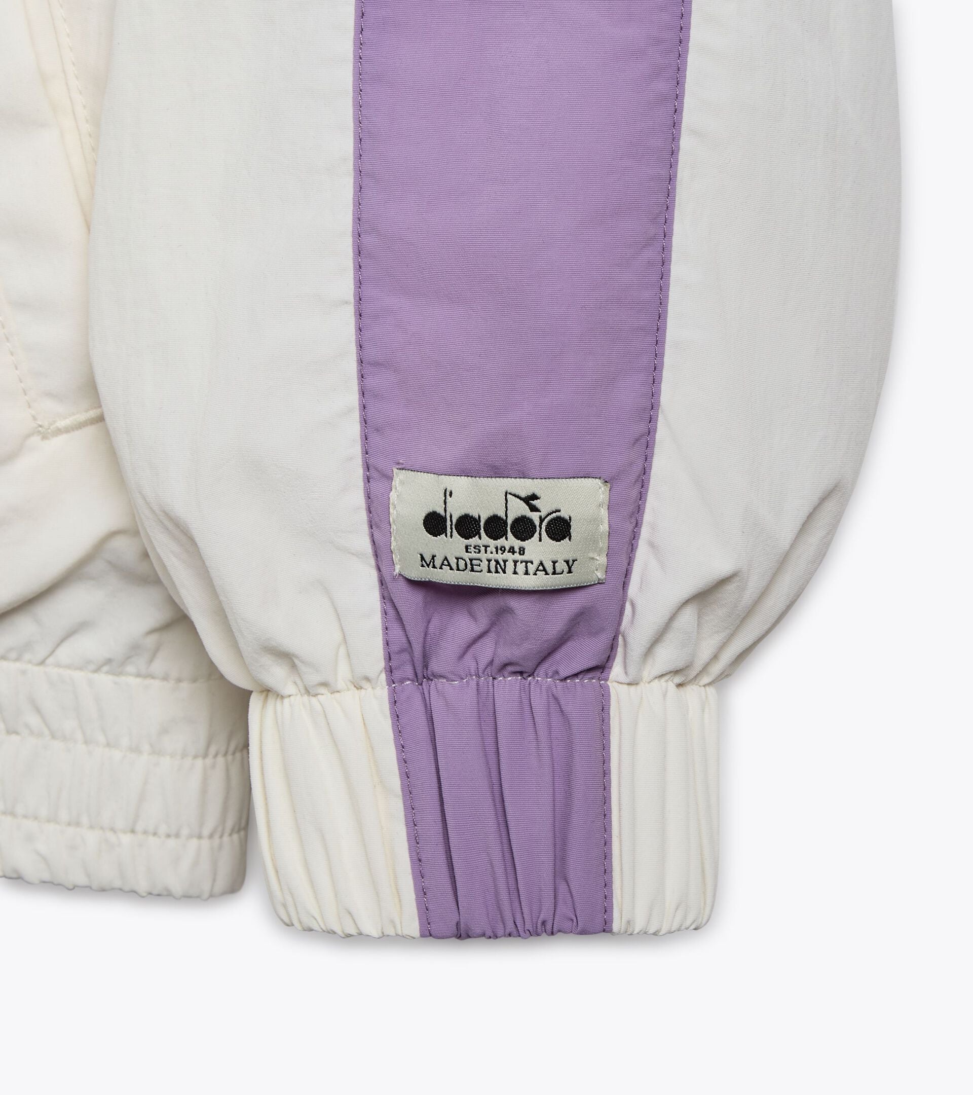 Gender-neutral track jacket with Mill City logo and purple accents, made in Italy.