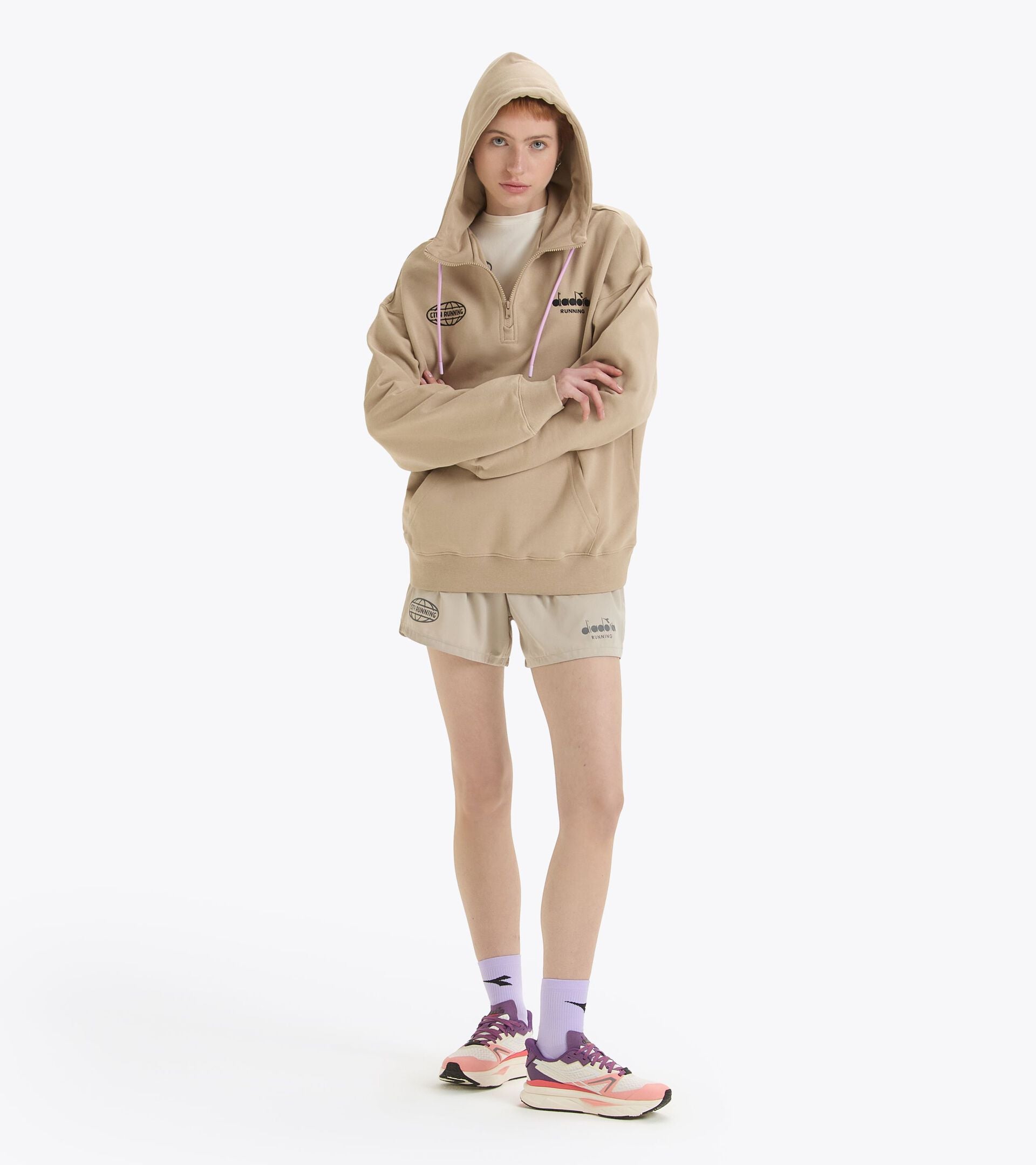 Gender-neutral beige hoodie with kangaroo pocket, made of French terry cotton, featuring embroidery and jacquard label.