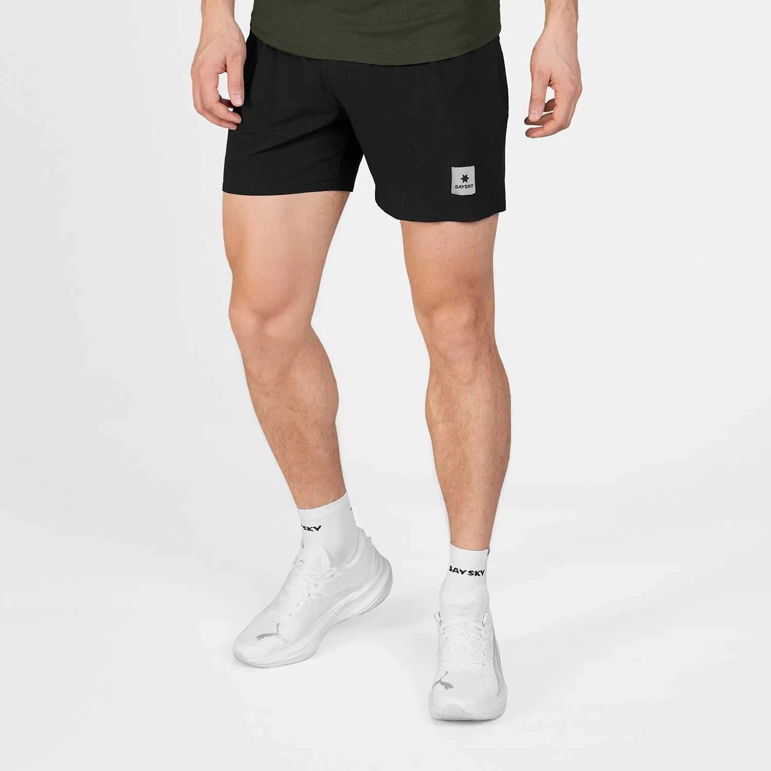 Men's black Flow Shorts 5'' in lightweight breathable fabric with elastic waistband and logo patch on leg.