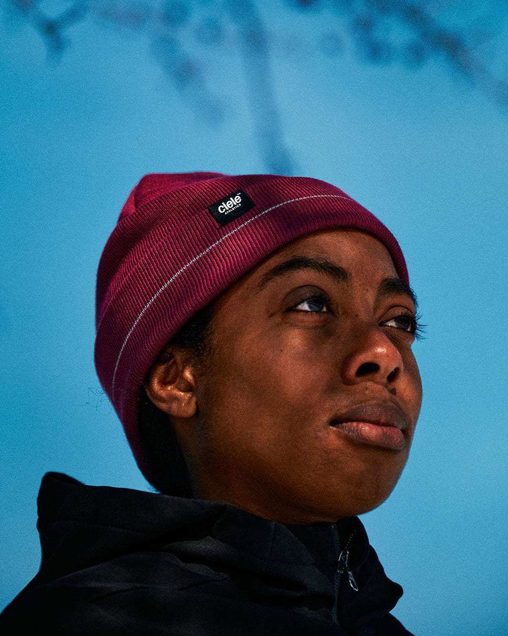 CR3Beanie - Cab in burgundy with reflective stripe, worn outdoors.