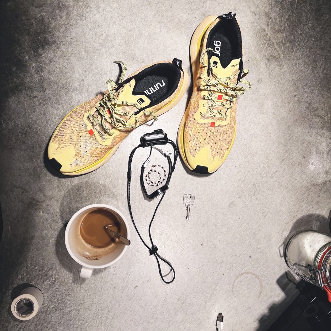 Yellow personality  running shoes on cement with a coffee cup and keys, showcasing "yellow personality."