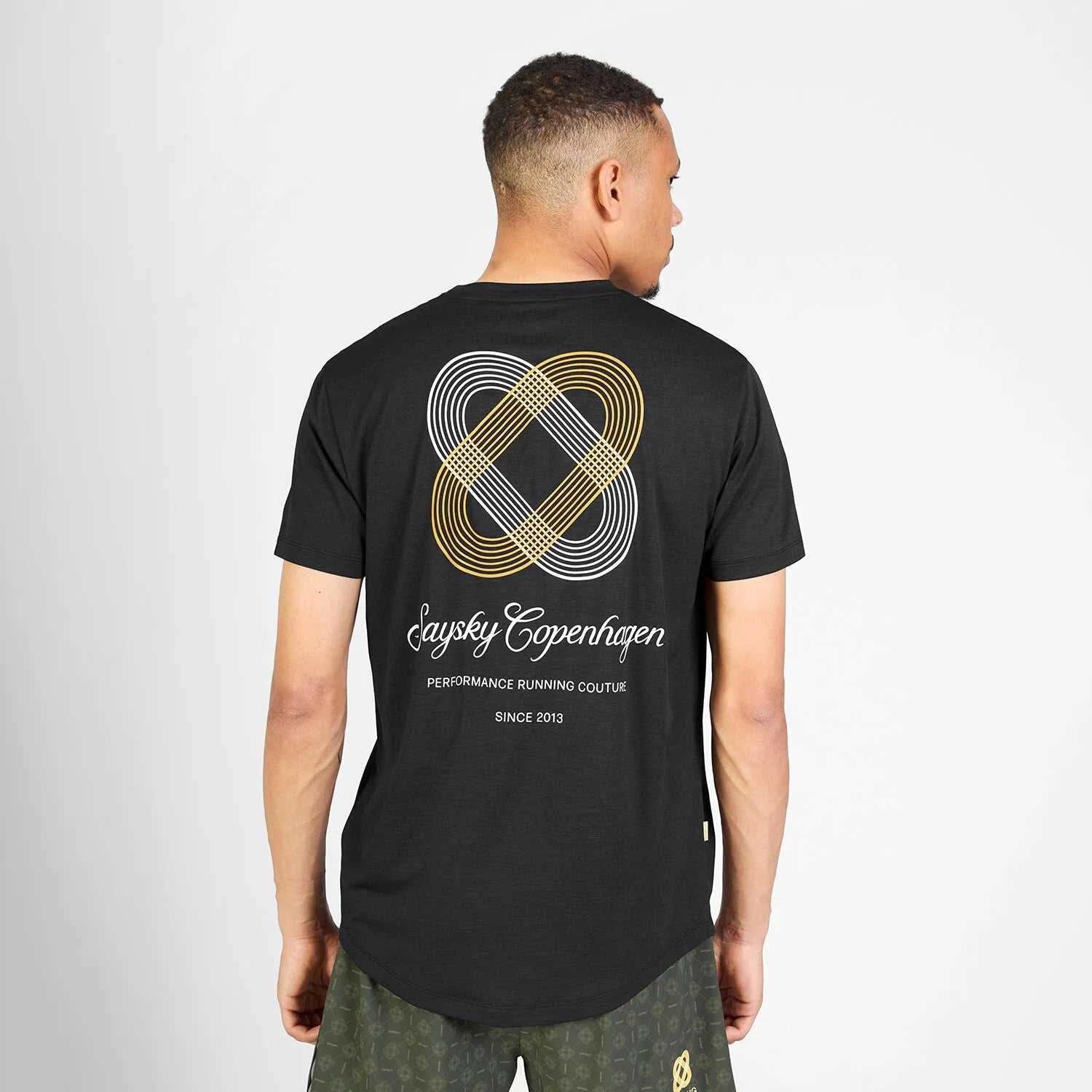 Black COUTURE STATEMENT COMBAT PRO T-shirt with white and gold geometric back design and cursive text, short sleeves, lightweight fabric.