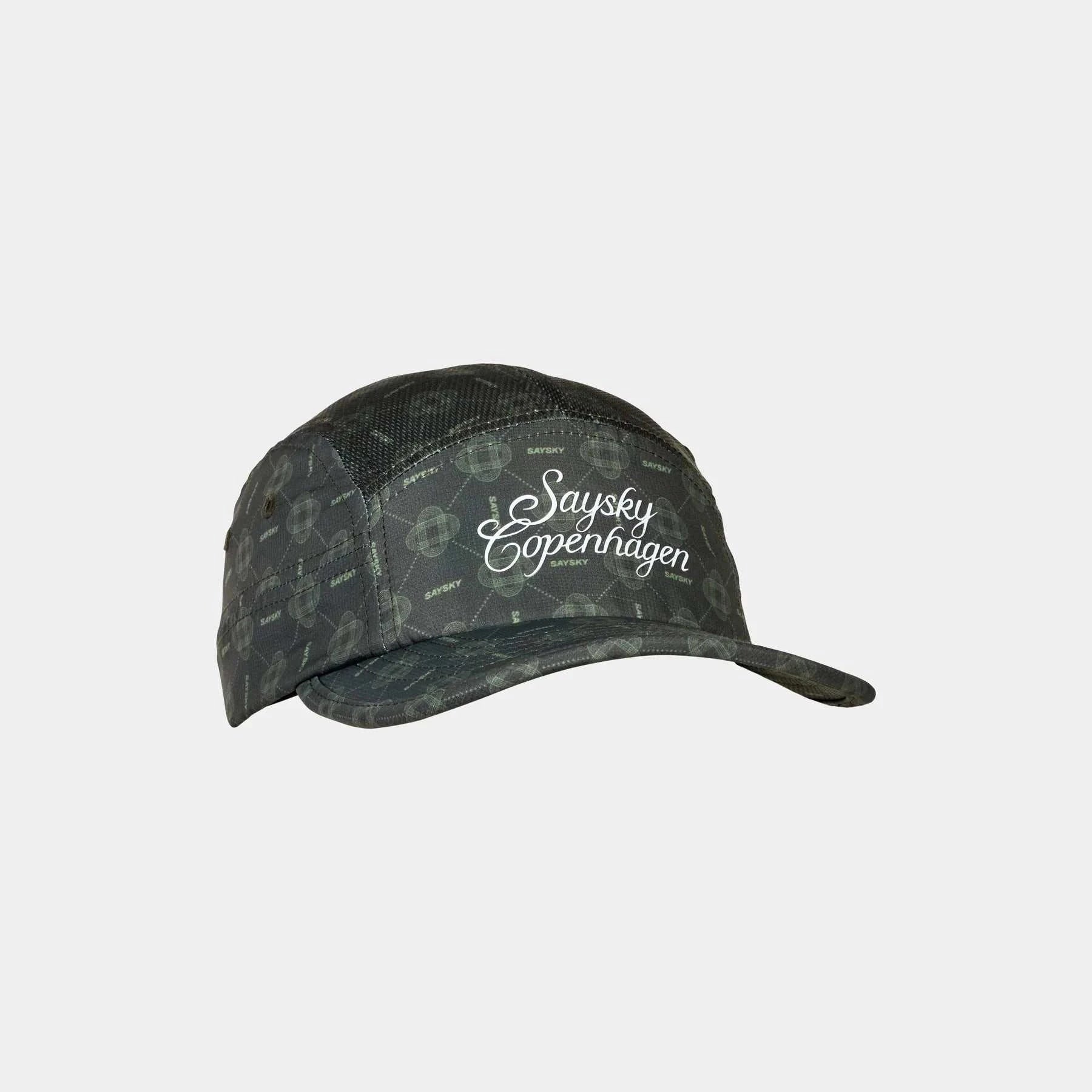 COUTURE COMBAT CAP in dark green polyester with subtle circular pattern, soft brim, breathable five-panel design, and front embossed logo.