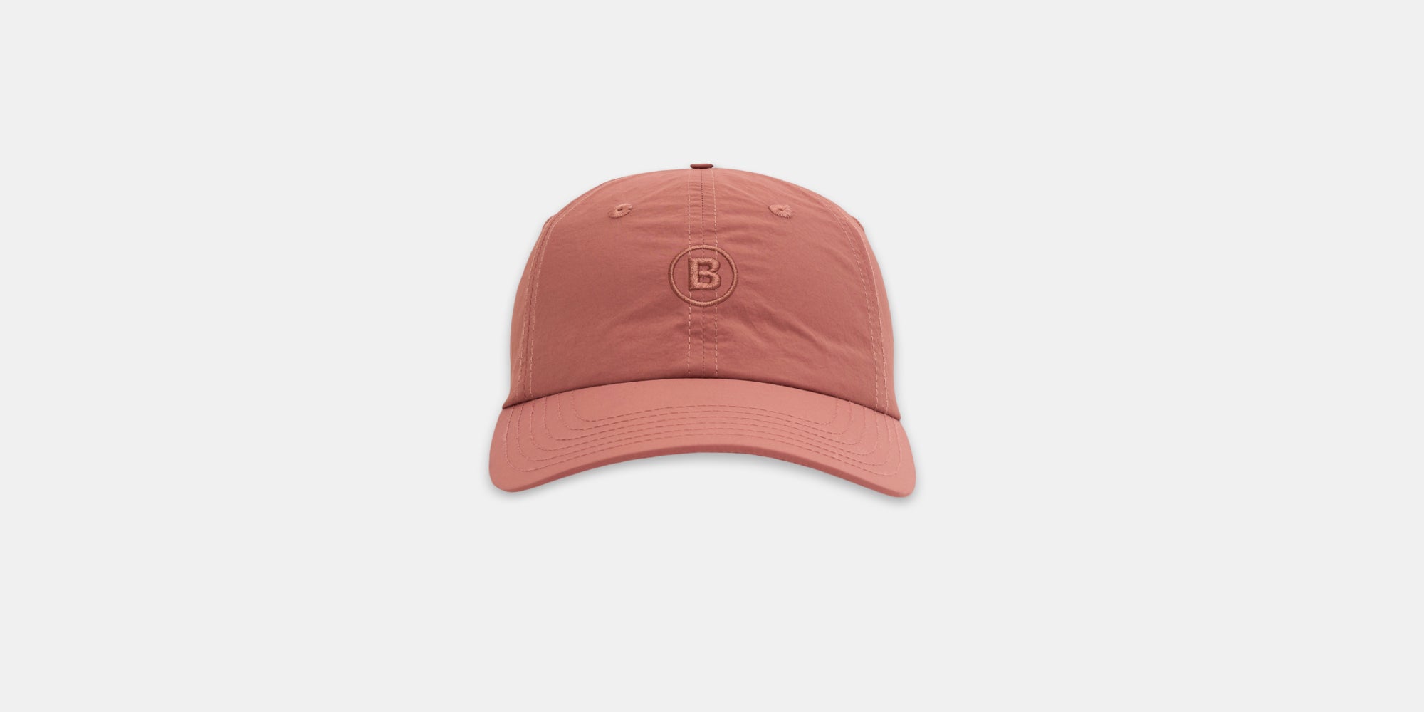 Embroidered Bandit Nylon Dad Hat in baked clay color with adjustable buckle and sweat-wicking fabric.