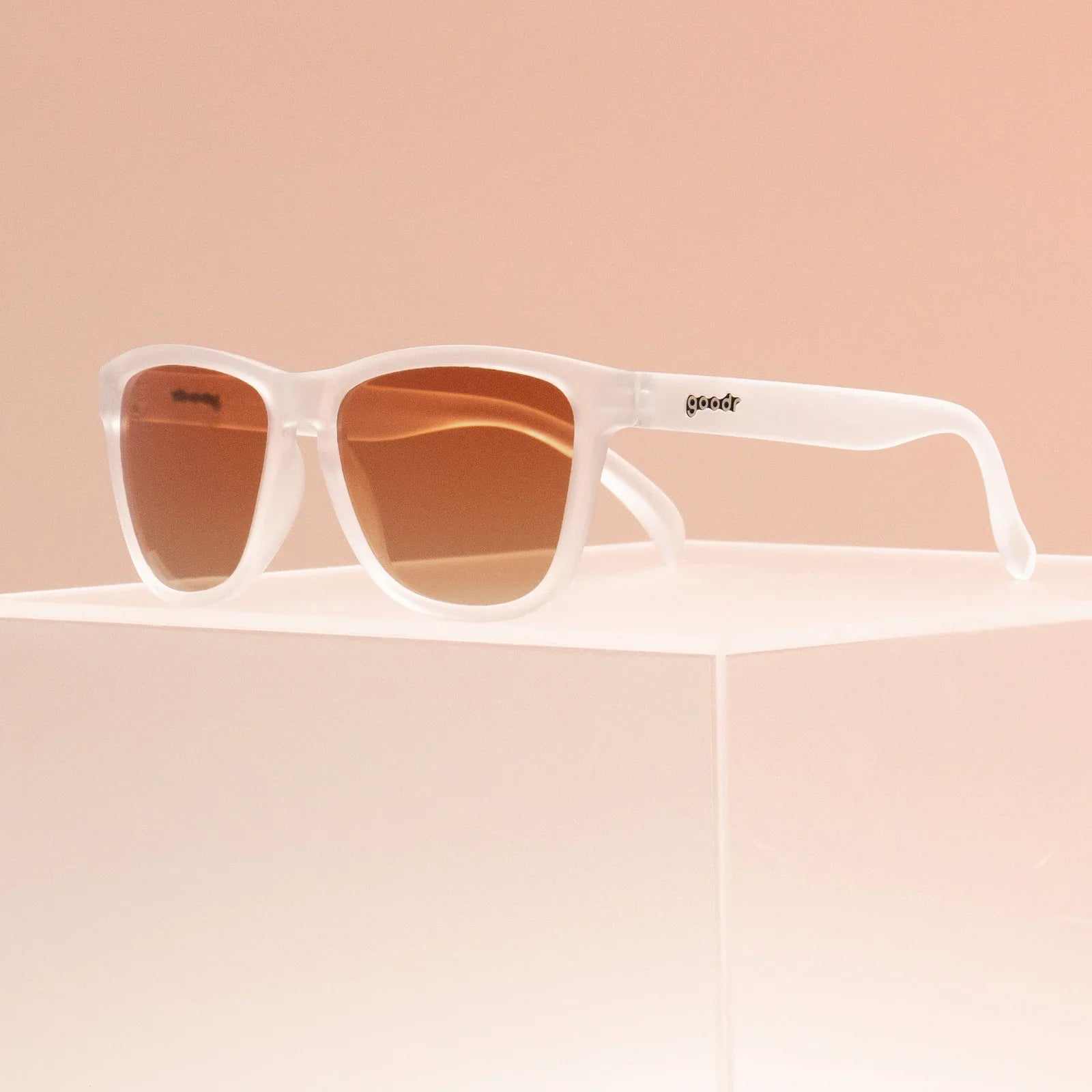 Clear translucent sunglasses with brown gradient lenses, named "Root Beer Sommelier," ideal for medium-sized faces.