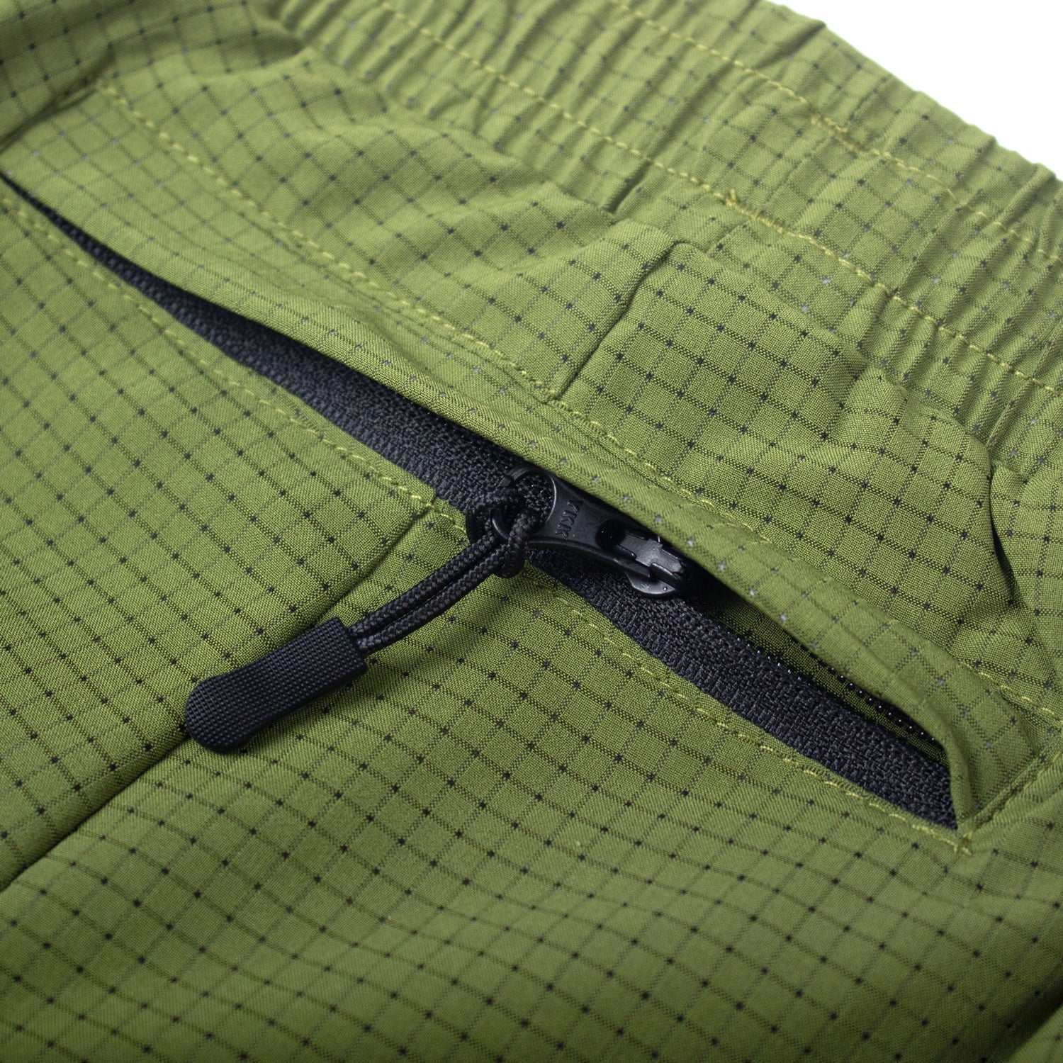 Olive green running shorts with zip pocket, moisture-wicking fabric, and recycled materials.