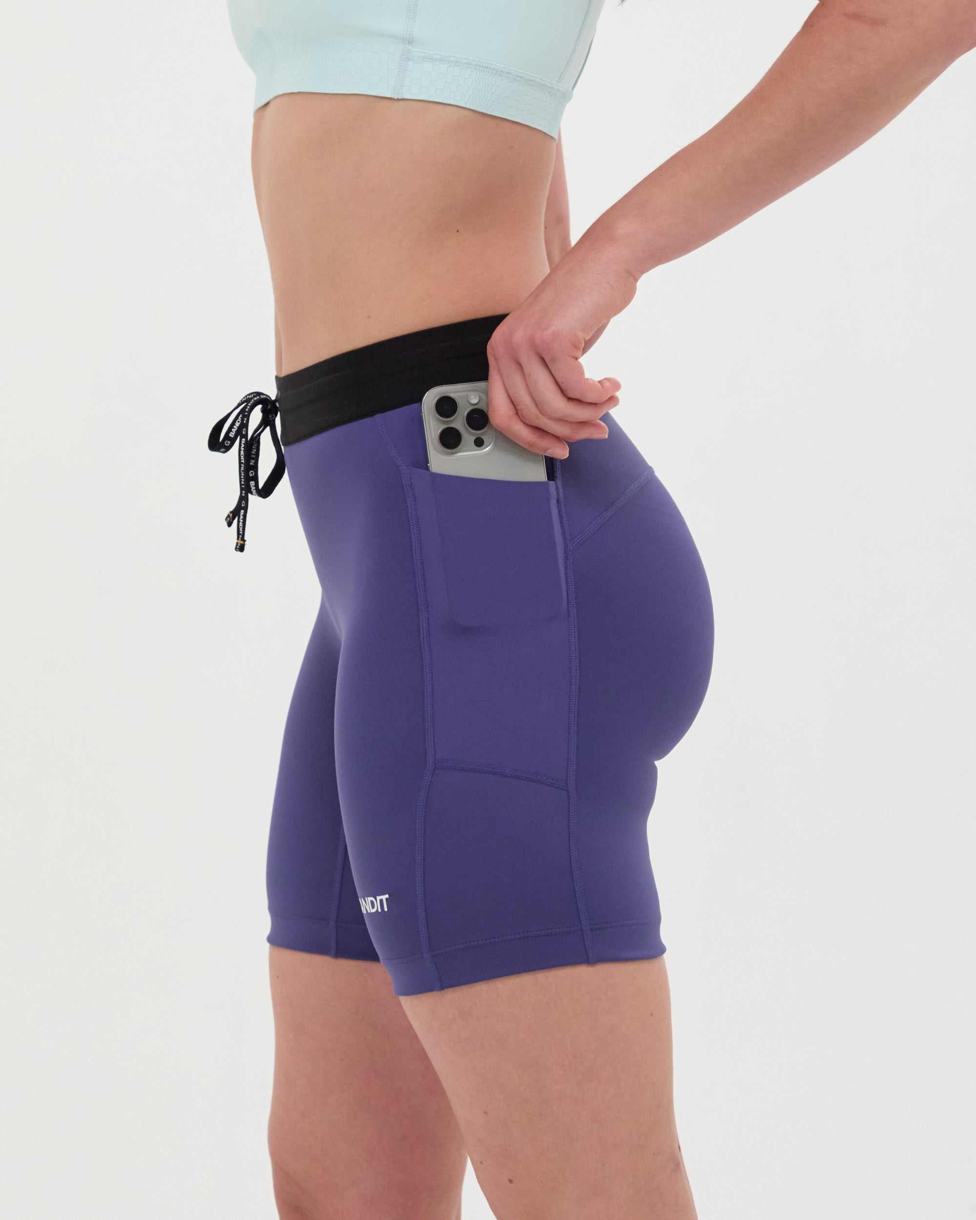 7" purple compression shorts with waterproof phone pocket and anti-chafe waistband.