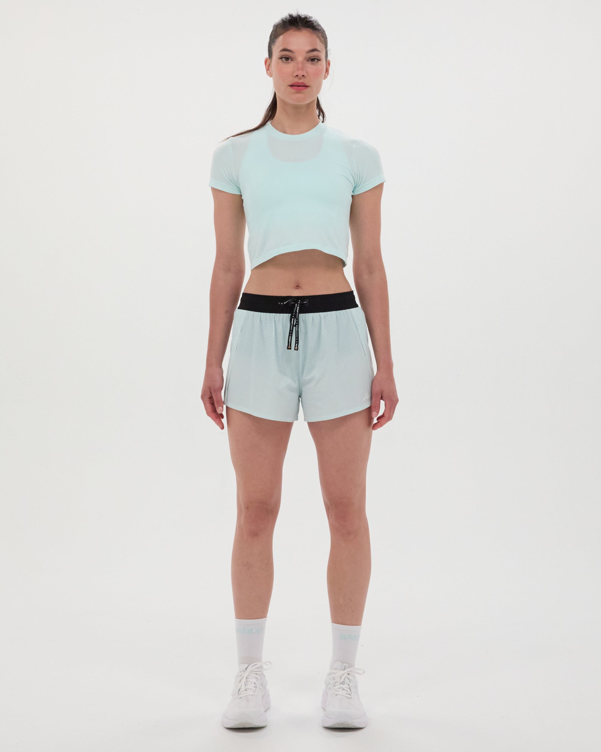 Women's Mercury Seamless™ Crop Tee in white, designed with soft, sweat-wicking fabric, rib crew neckline, and cropped fit for running.