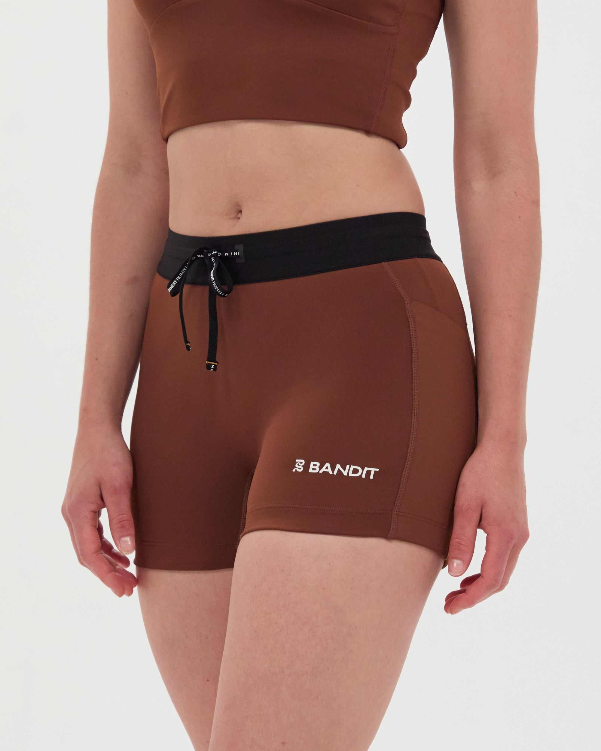 Stamina™ 3" Compression shorts in Coffee Bean color, featuring high-waist fit, dual phone pockets, and reflective logos.