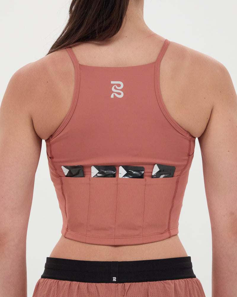 Back view of the Stamina™ 7 Pocket Nova Crop in Baked Clay showcasing multiple pockets and sleek design.