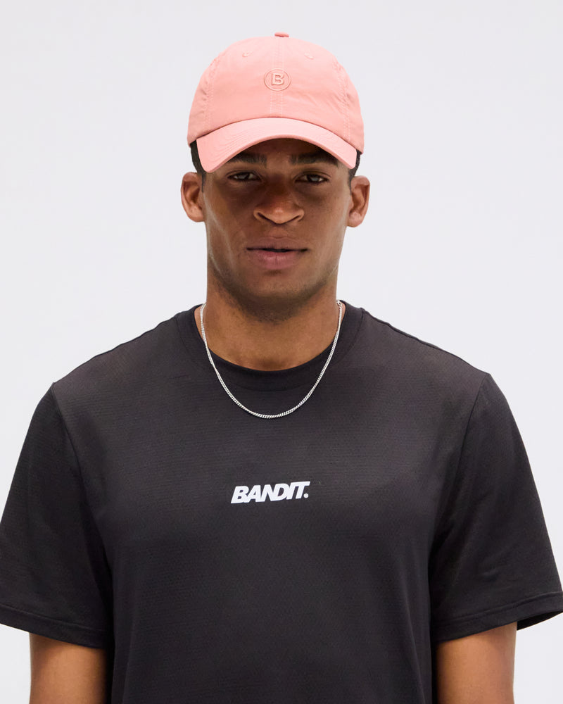 Embroidered Bandit nylon dad hat in baked clay color.