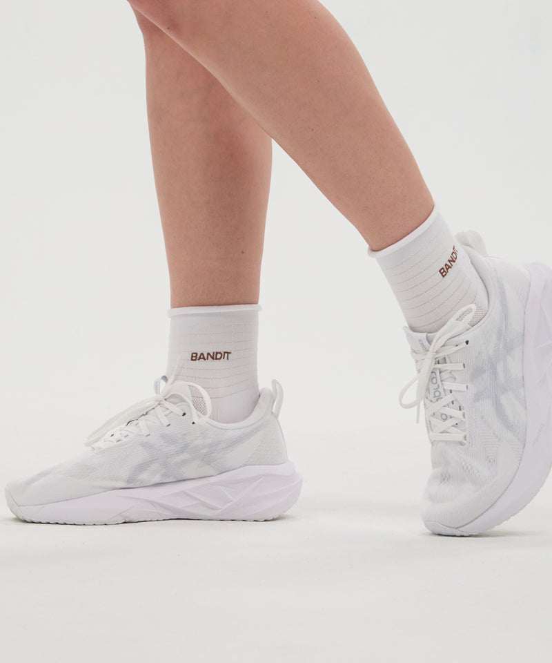 Grid Knit™ Run Socks in white with Baked Clay detail, shown in a 2-pack worn with white sneakers.