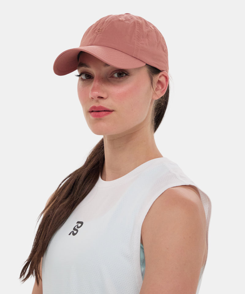 Embroidered Bandit nylon dad hat in baked clay color, worn by a model.