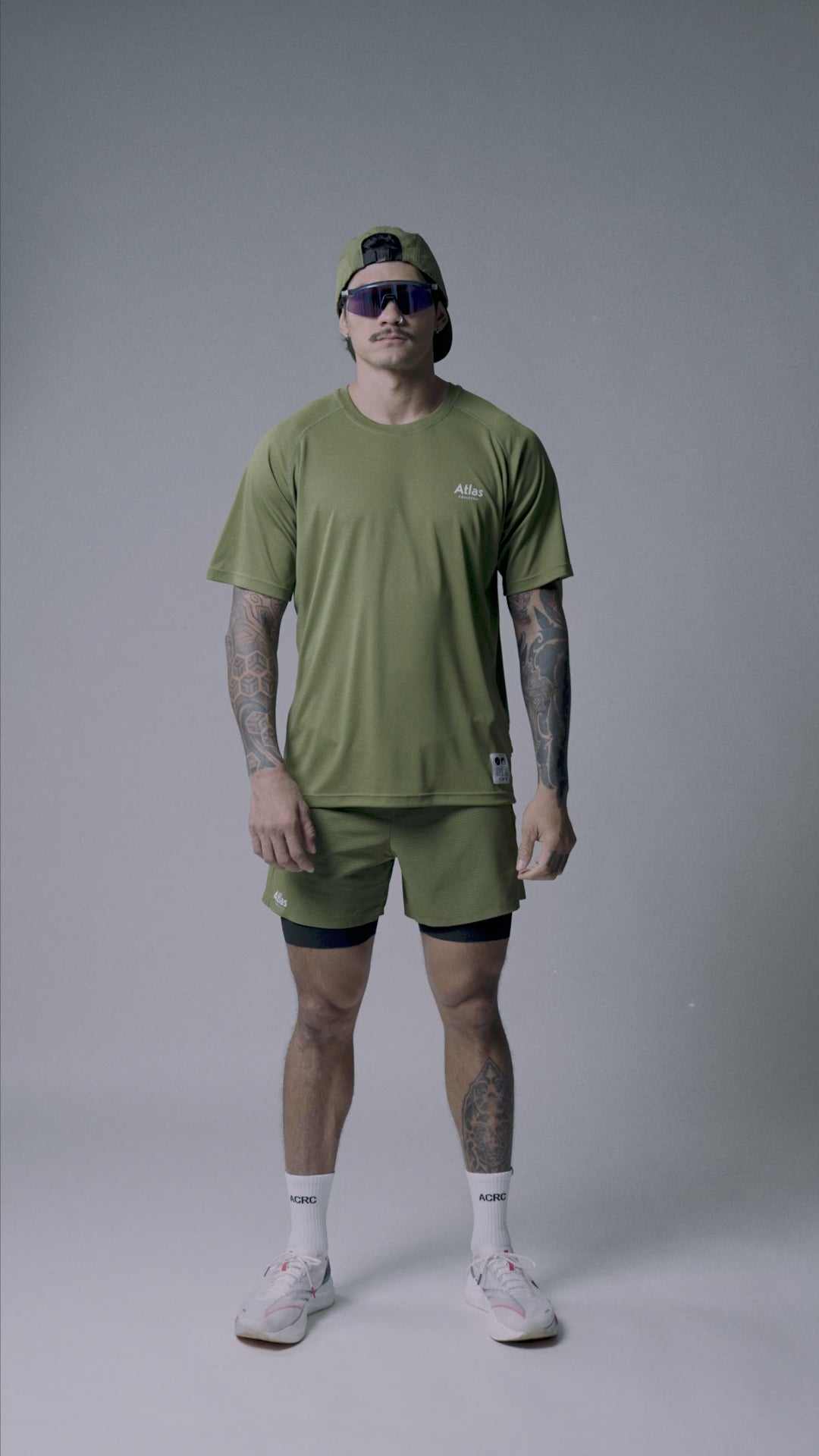 Olive green tight fit 2-in-1 running shorts with moisture-wicking and odor resistance.