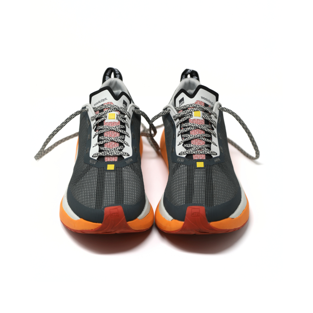 gender-neutral running shoes with roomy forefoot and orange accents
