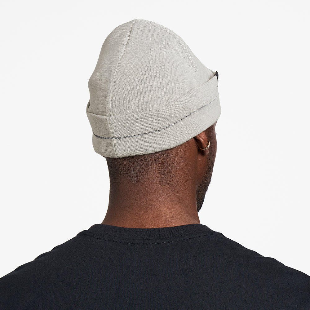 CR3Beanie - Stadium, light gray color, worn by a person, featuring reflective stripe and durable recycled polyester material.