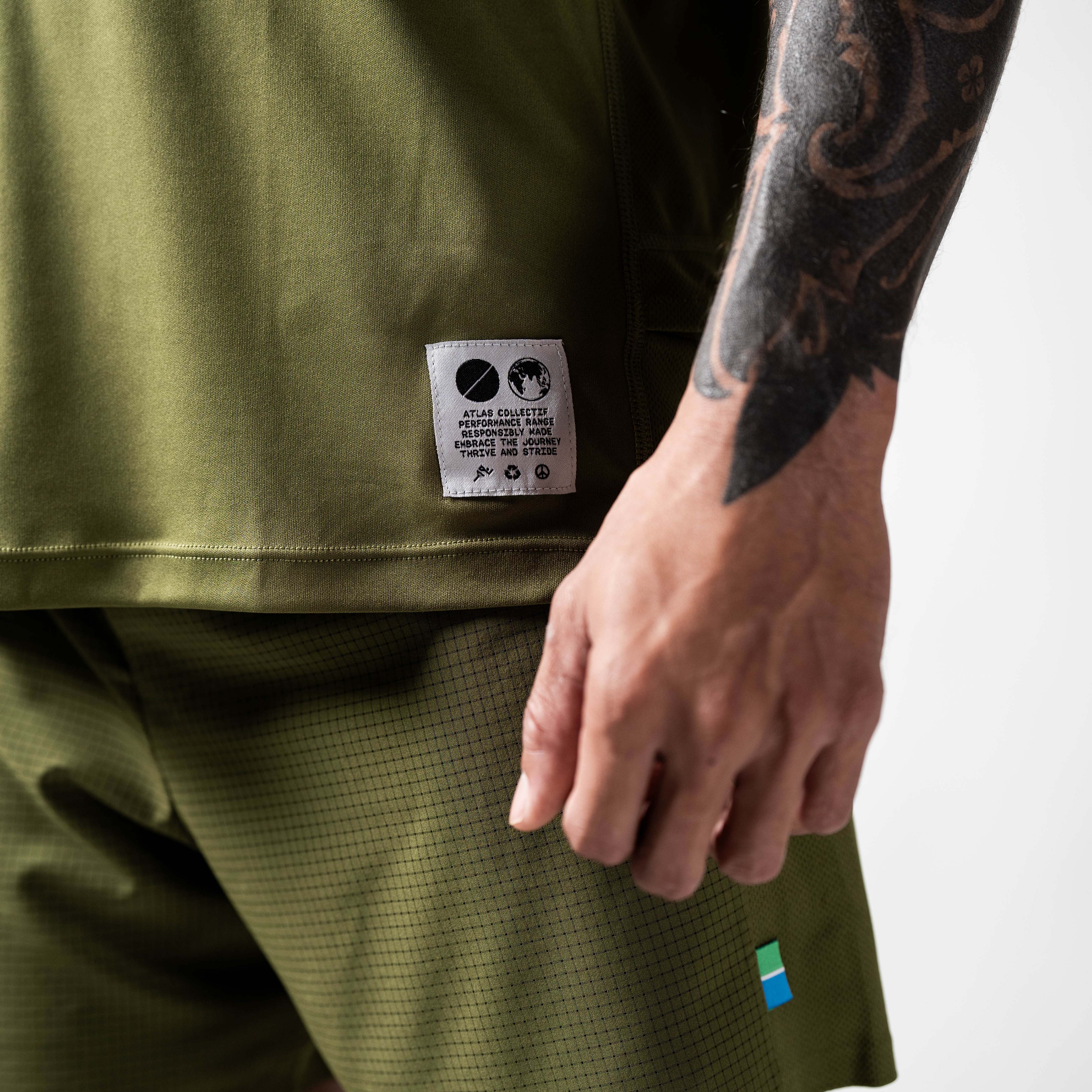 Olive green performance running T-shirt made from recycled materials, featuring moisture-wicking and quick-drying properties.