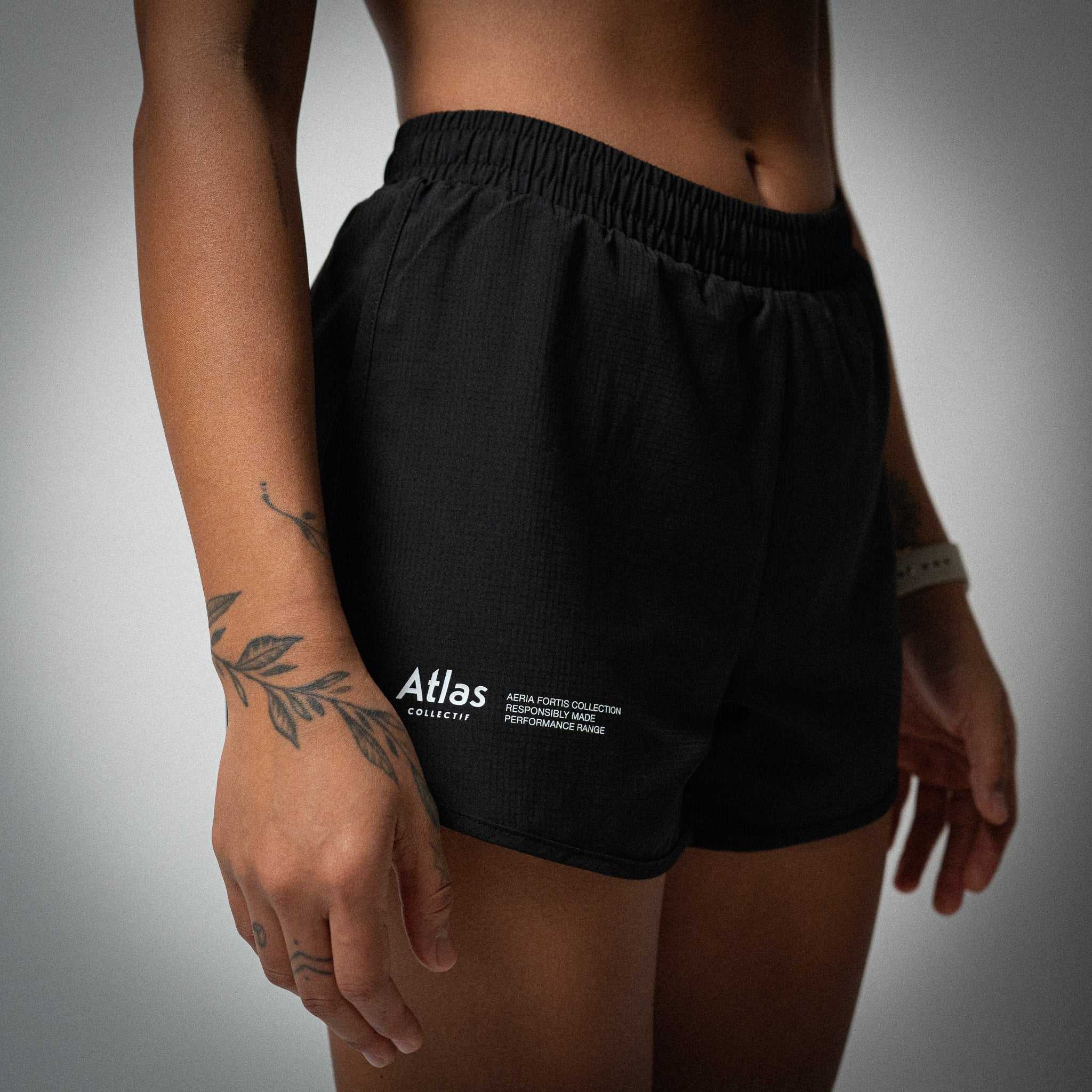 Black Aeria Fortis Race Shorts for women with elastic waistband and zippered back pocket, designed for comfort and breathability.