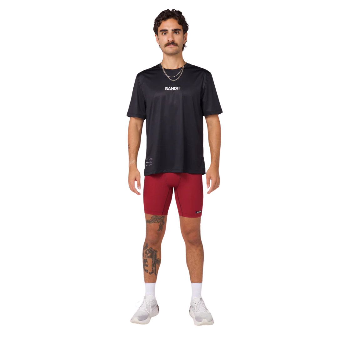 Black performance tee with "Bandit" text, featuring a classic crew neckline and side slit detail; limited run seasonal graphic on back. moisture-wicking
