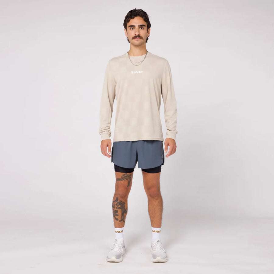 Unisex Bandit Cheque Jacquard Long Sleeve in stone color, featuring performance knit fabric, crew neckline, and seasonal graphic design.