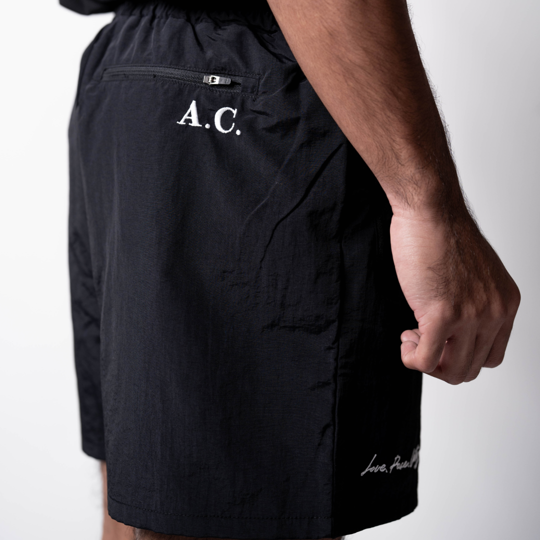 LPU 5" Running Shorts in black featuring sustainable wrinkle-free polyester, side and back pockets with YKK zippers.