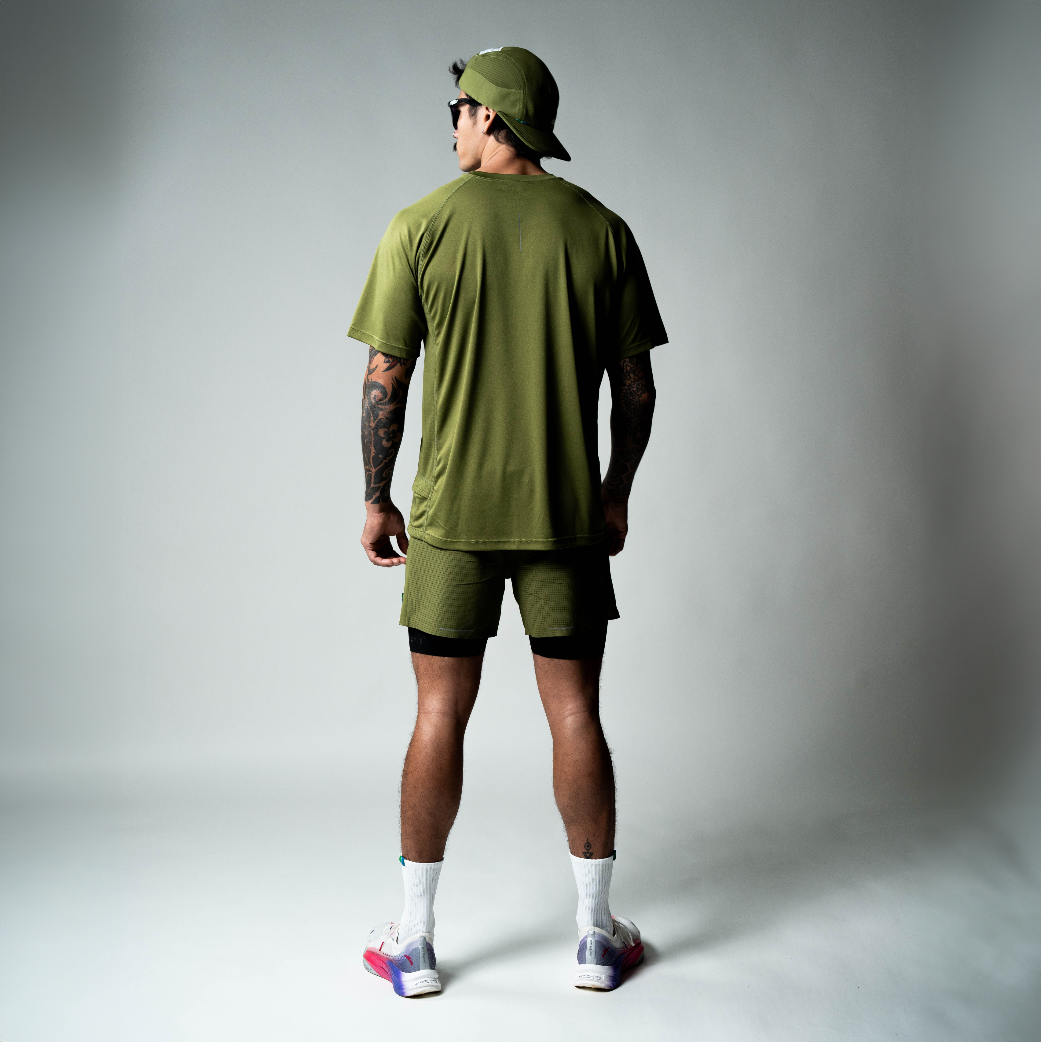Performance running T-shirt in olive green showcasing athletic fit, made from recycled materials.