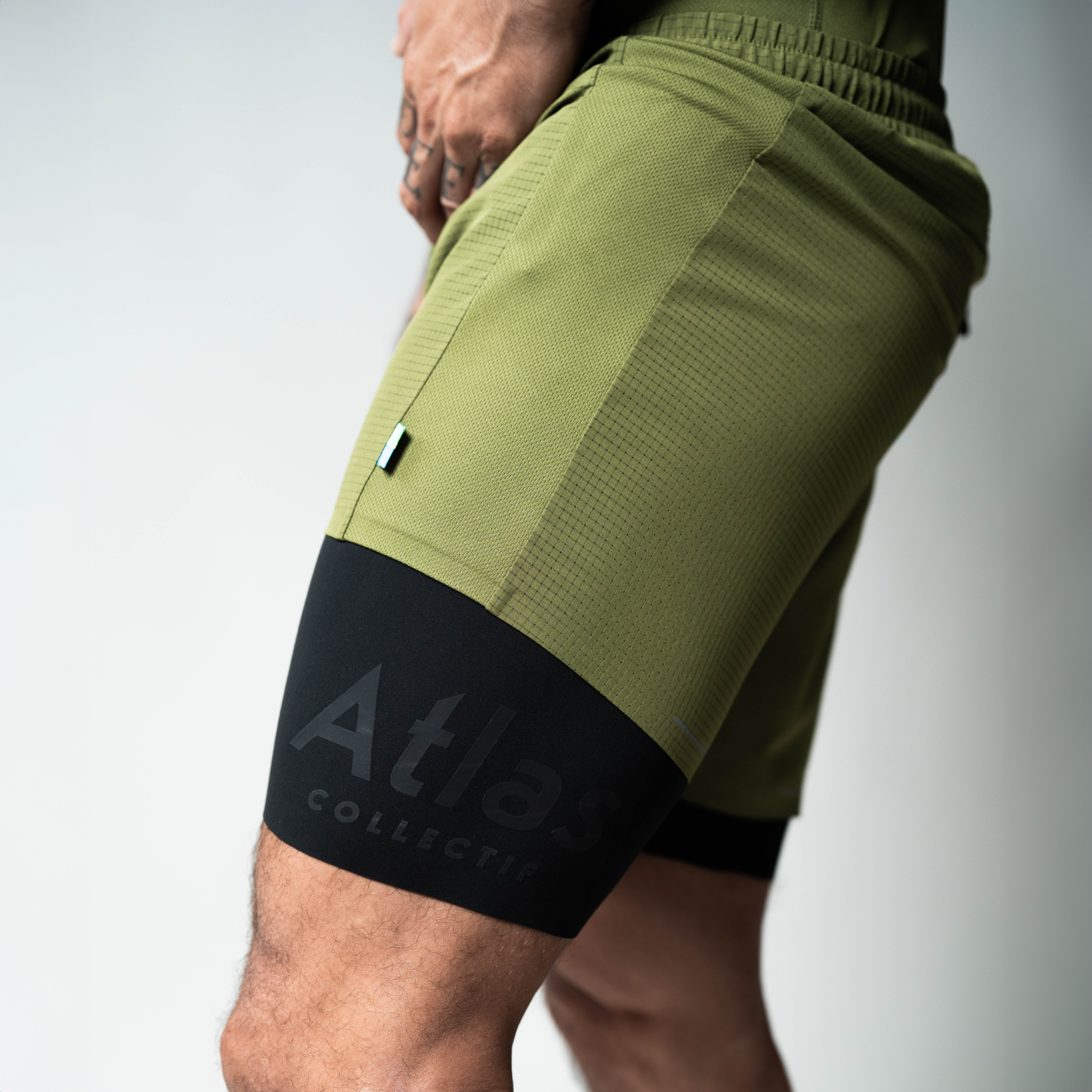 Performance 2 in 1 Running Shorts in Olive Green, tight fit, made from recycled materials, features moisture-wicking and quick-drying fabric.