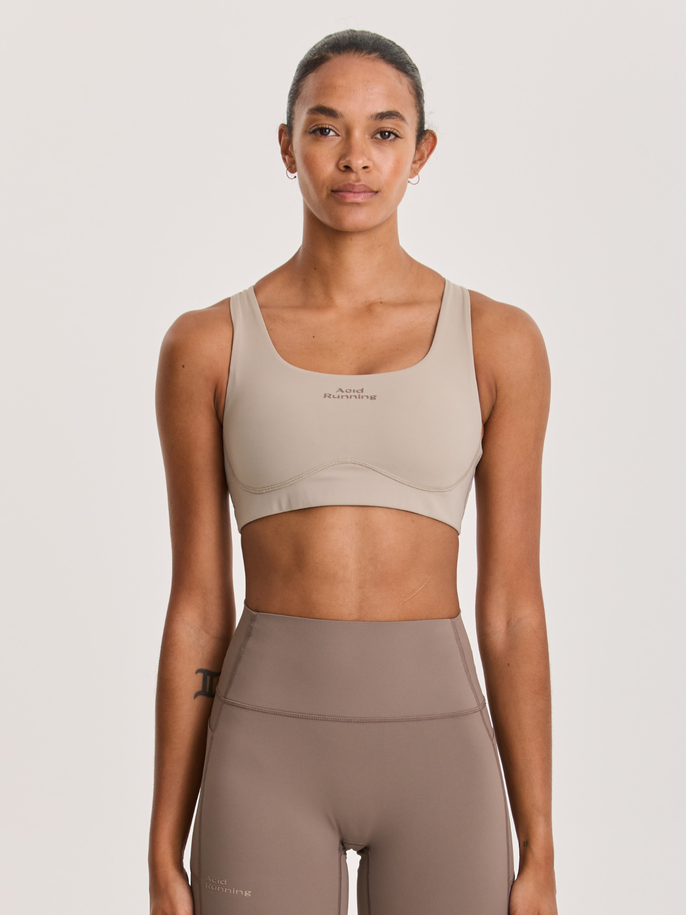 Women's High Impact Running Bra in beige with square neckline, underbust seam, and smooth, stretch fabric for firm support and breathability.