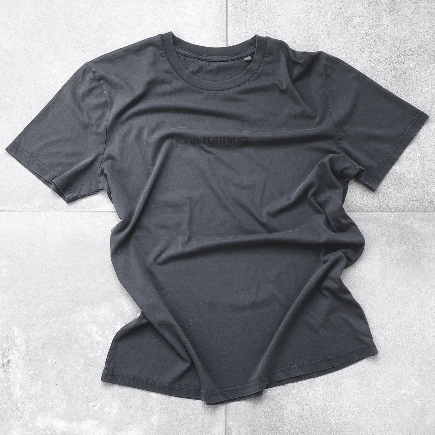 Unisex running tee in vintage black, 100% organic cotton, non-chafing, improves with age.