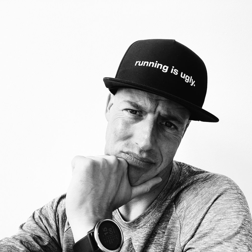 technical trucker cap with "running is ugly" slogan, adjustable snapback, ventilated panels