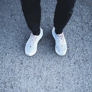White sneakers on pavement, designed for comfortable long runs on Sundays.