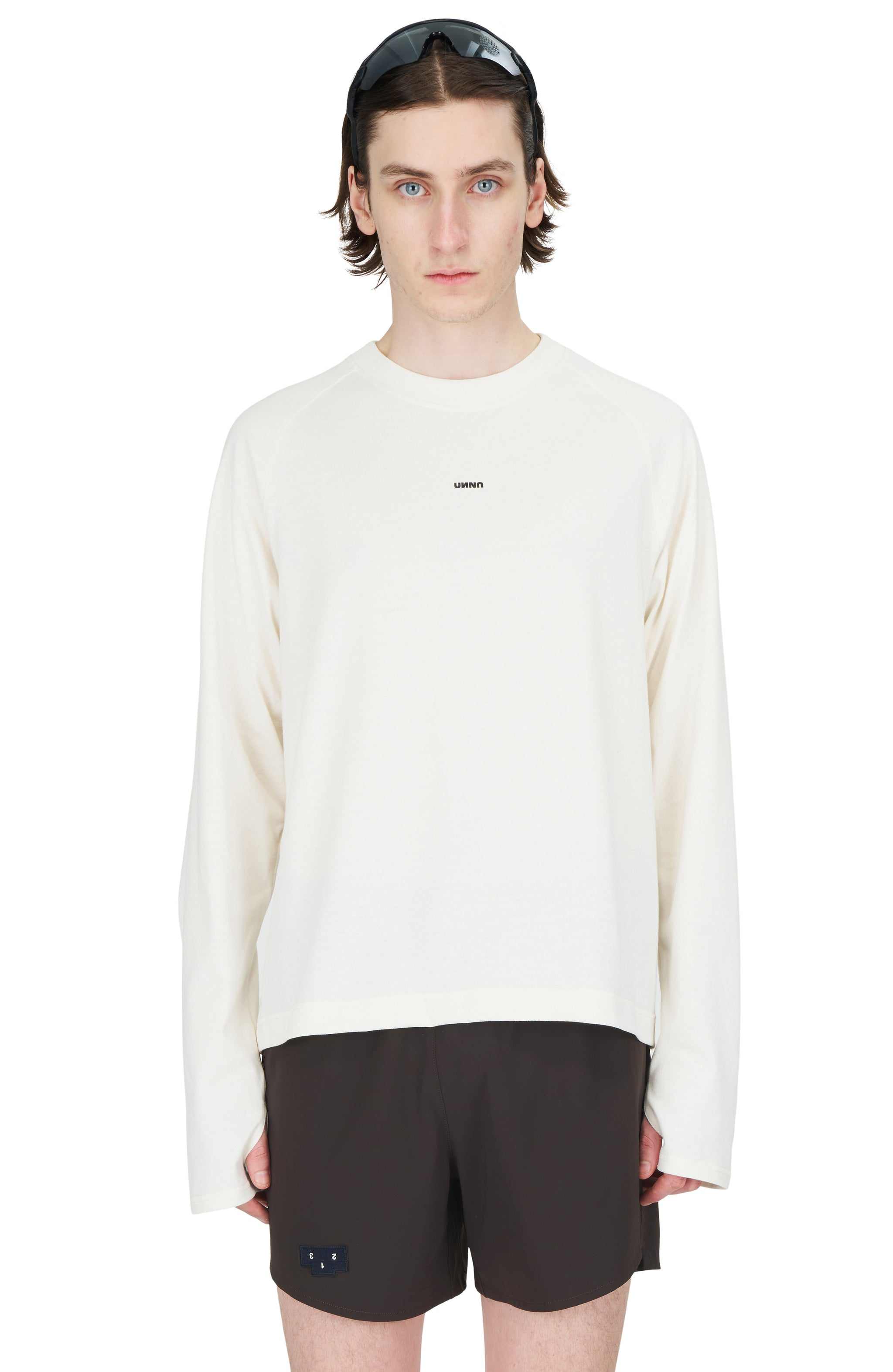 Men's vanilla white long sleeve raglan T-shirt with Unna logo, thumb holes, and UNNA Smiles Club print.