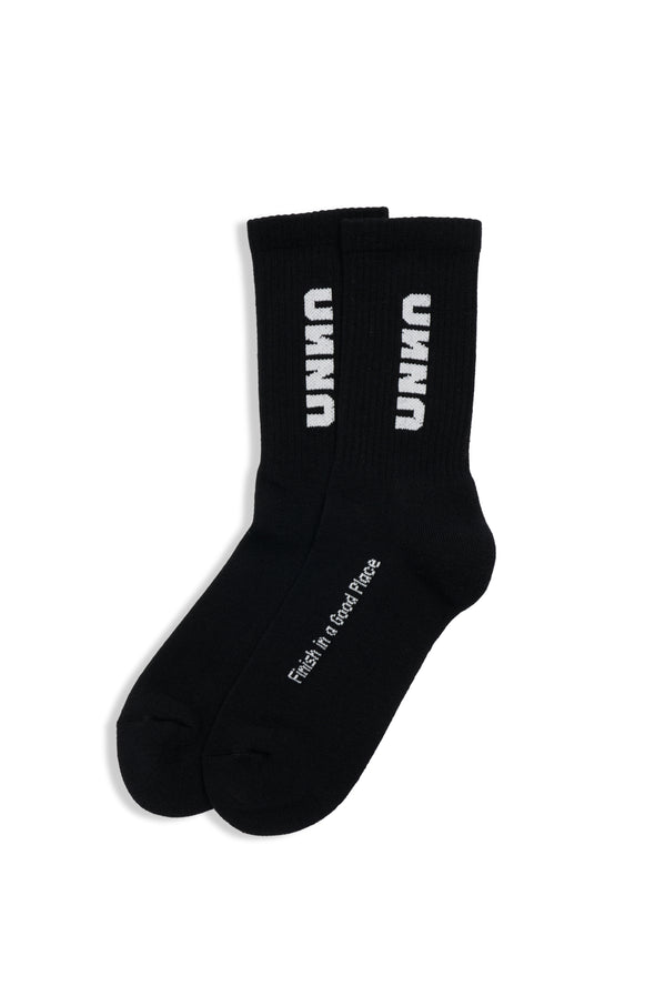 Black recycled running socks with stitched UNNA logo, made from 85% recycled cotton.