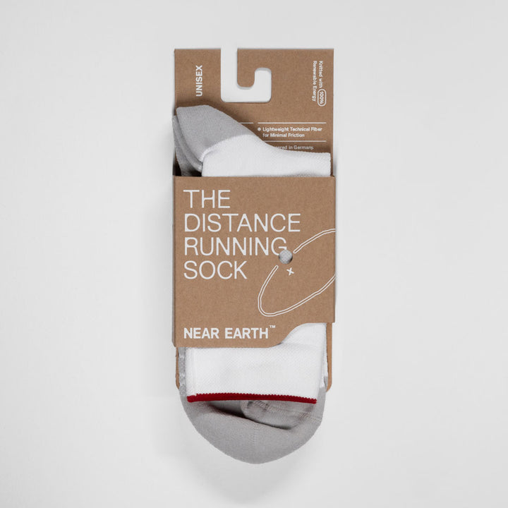 Near Earth Distance white running socks packaging.