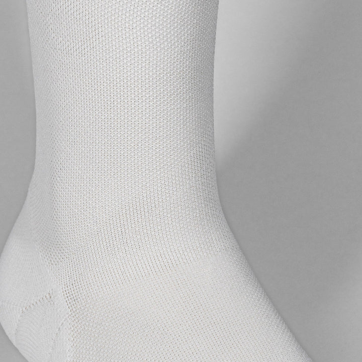 Ultralight white race day sock with breathable fibers and targeted compression.