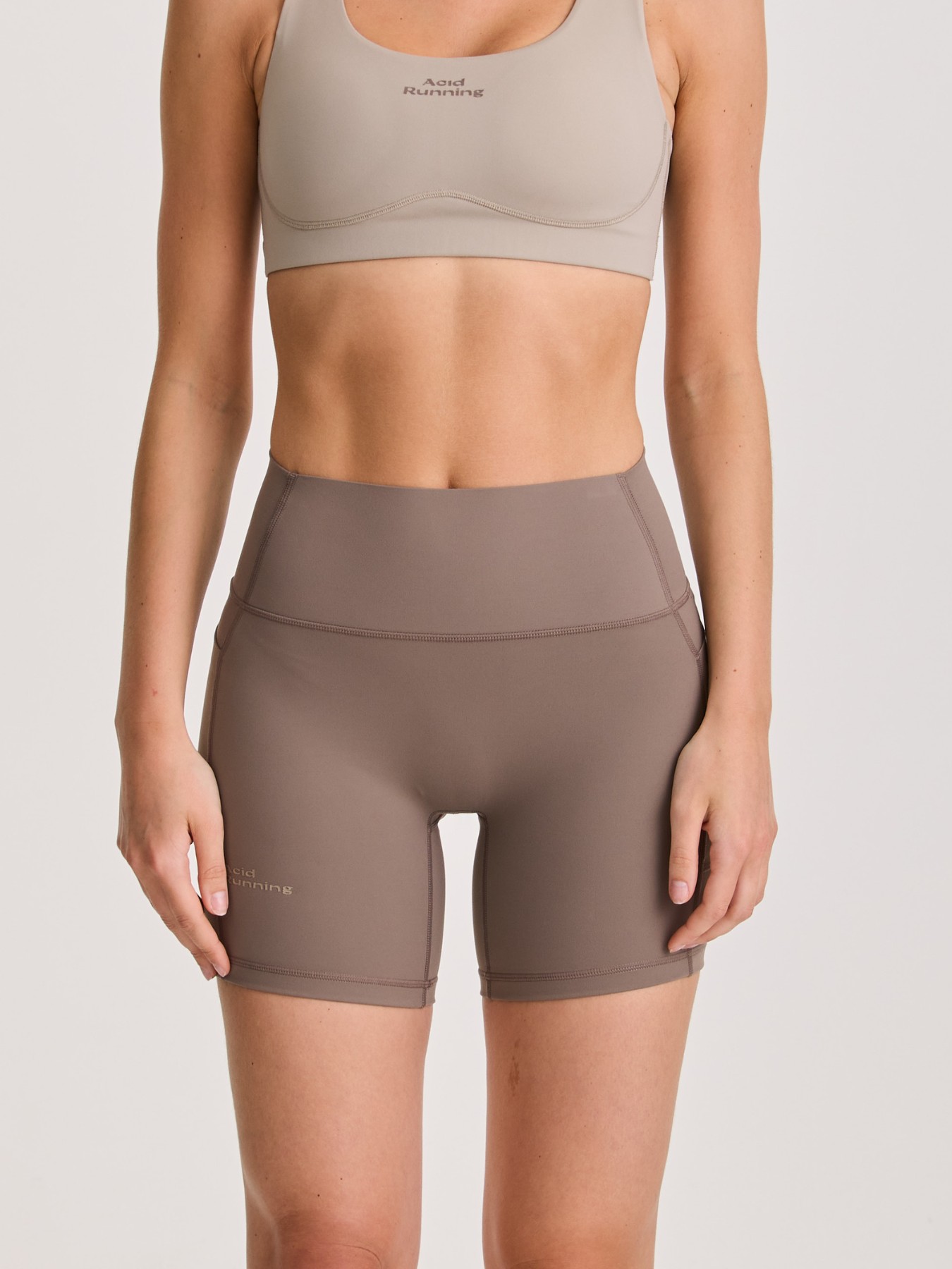 Women's Performance Shorts in falcon brown with a high-waisted, compressive fit and side pockets made from four-way stretch fabric.