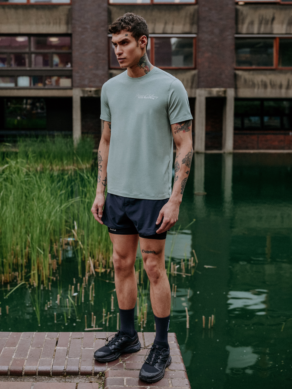 Runner's Fate T-Shirt in Iced Green featuring off-white prints, worn by a model outdoors.