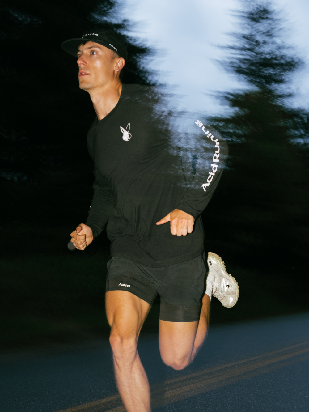Long sleeve black t-shirt with white graphics, worn by runner.