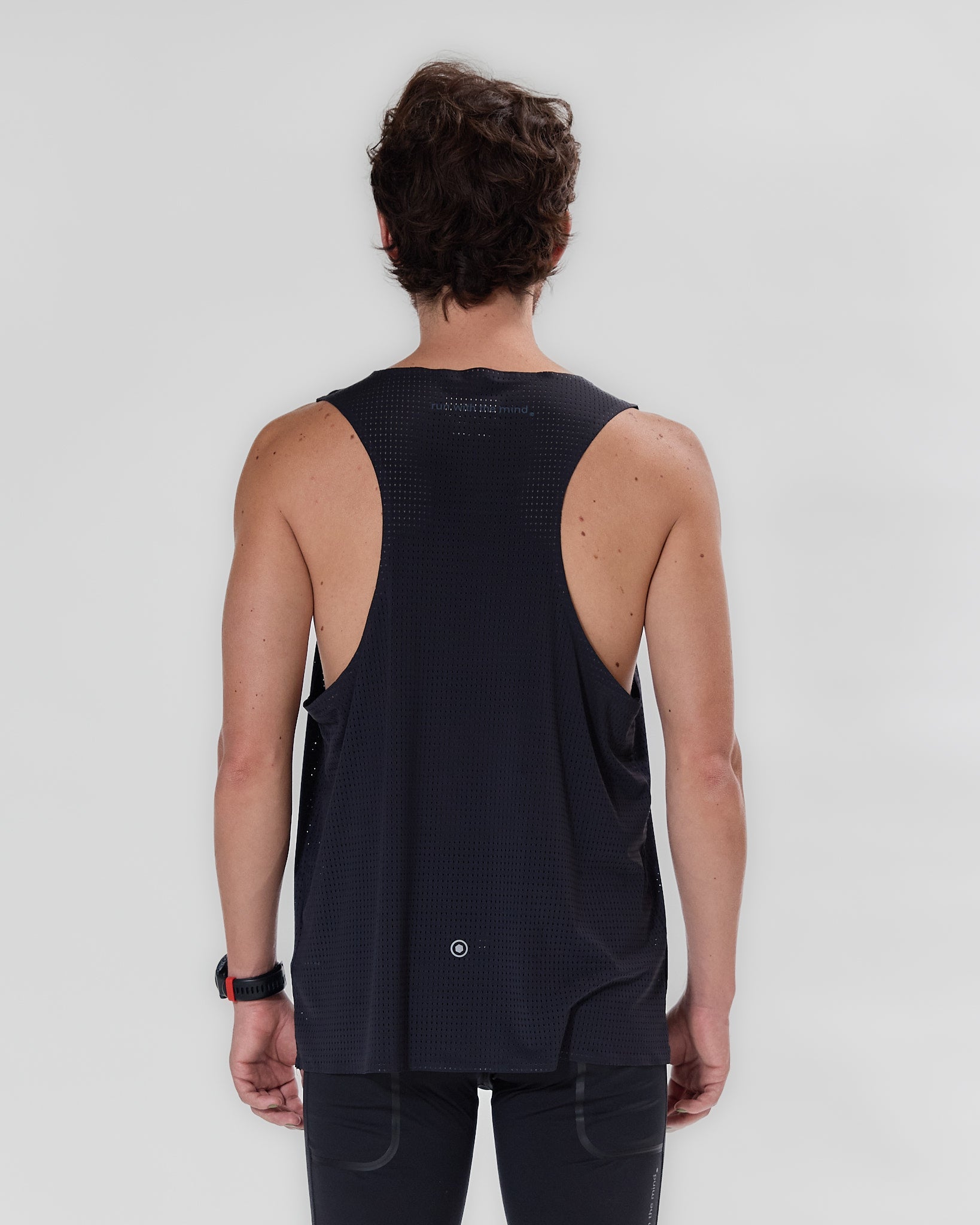 Koumori Training Singlet in black, showcasing breathable design and minimal reflective logo.