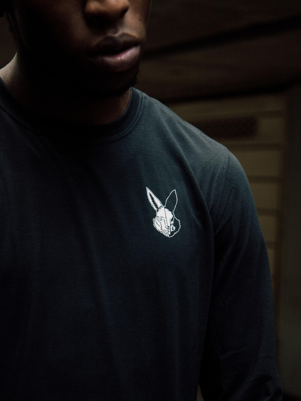 Eco-friendly black long sleeve t-shirt with white prints, sweat-wicking, odor resistant, made from organic and recycled fabrics.