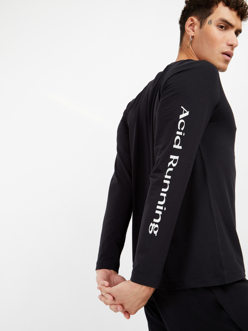 Long sleeve black t-shirt with white prints on arm, featuring advanced sweat-wicking fabric.