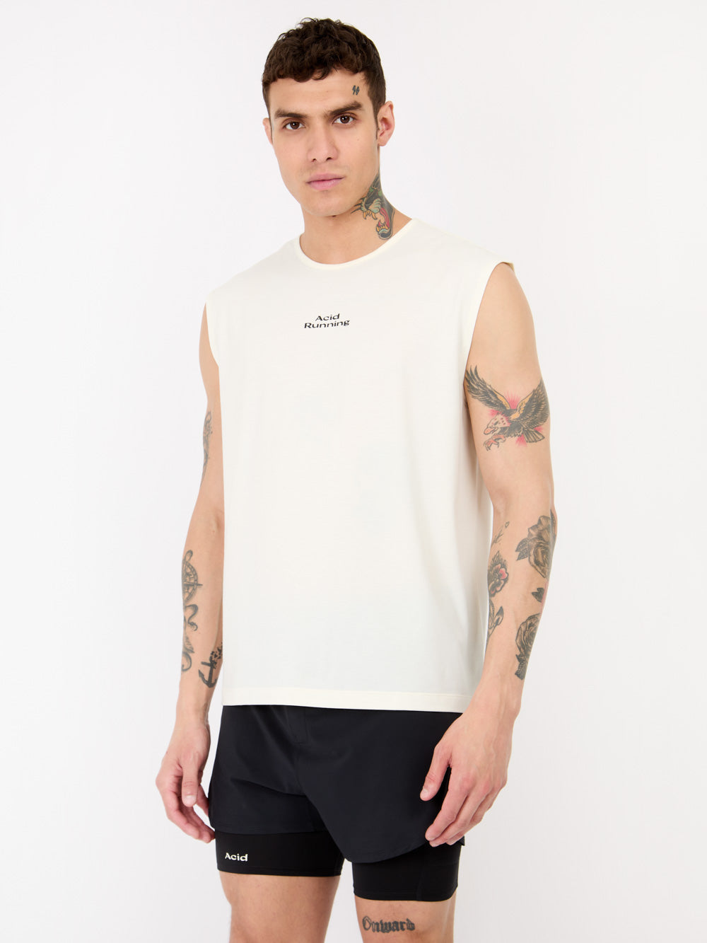 Men's logo tank in bone color, lightweight and sweat-wicking fabric, relaxed fit on male model