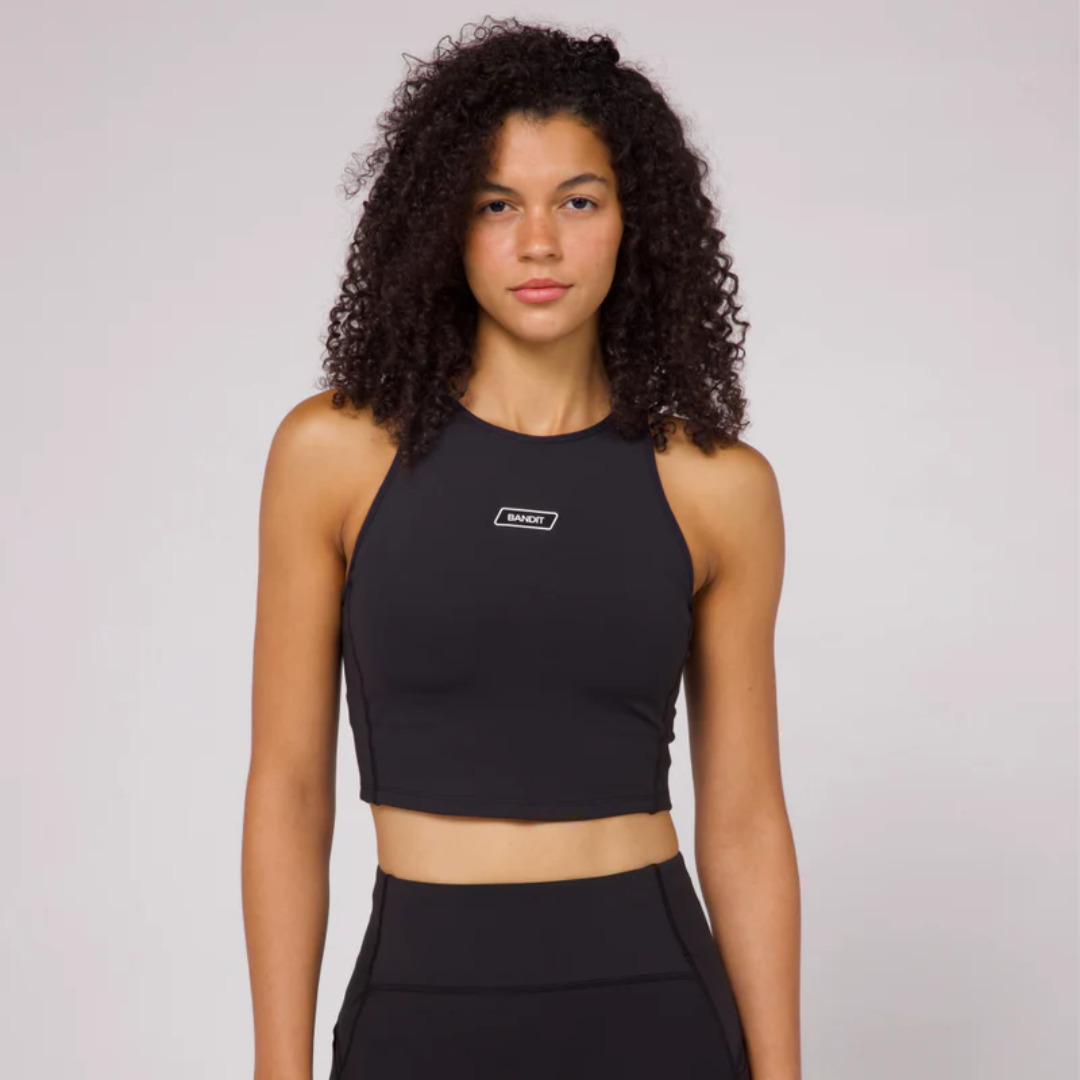 Stamina Luna Race Crop in black, featuring three pockets and flattering halter silhouette.