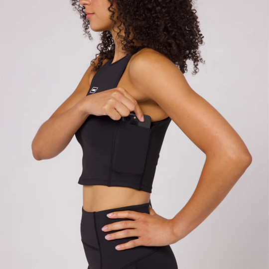 Stamina Luna Race Crop in black with built-in pockets and halter silhouette.
