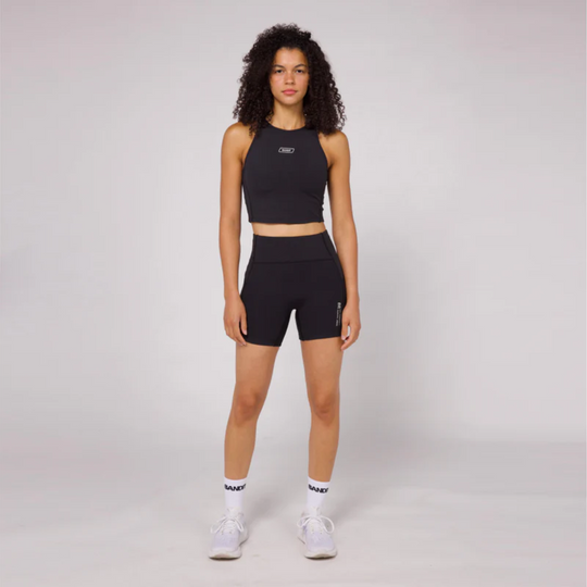 Stamina Luna Race Crop in black, featuring a halter silhouette, three phone-sized pockets, and moisture-wicking performance fabric.