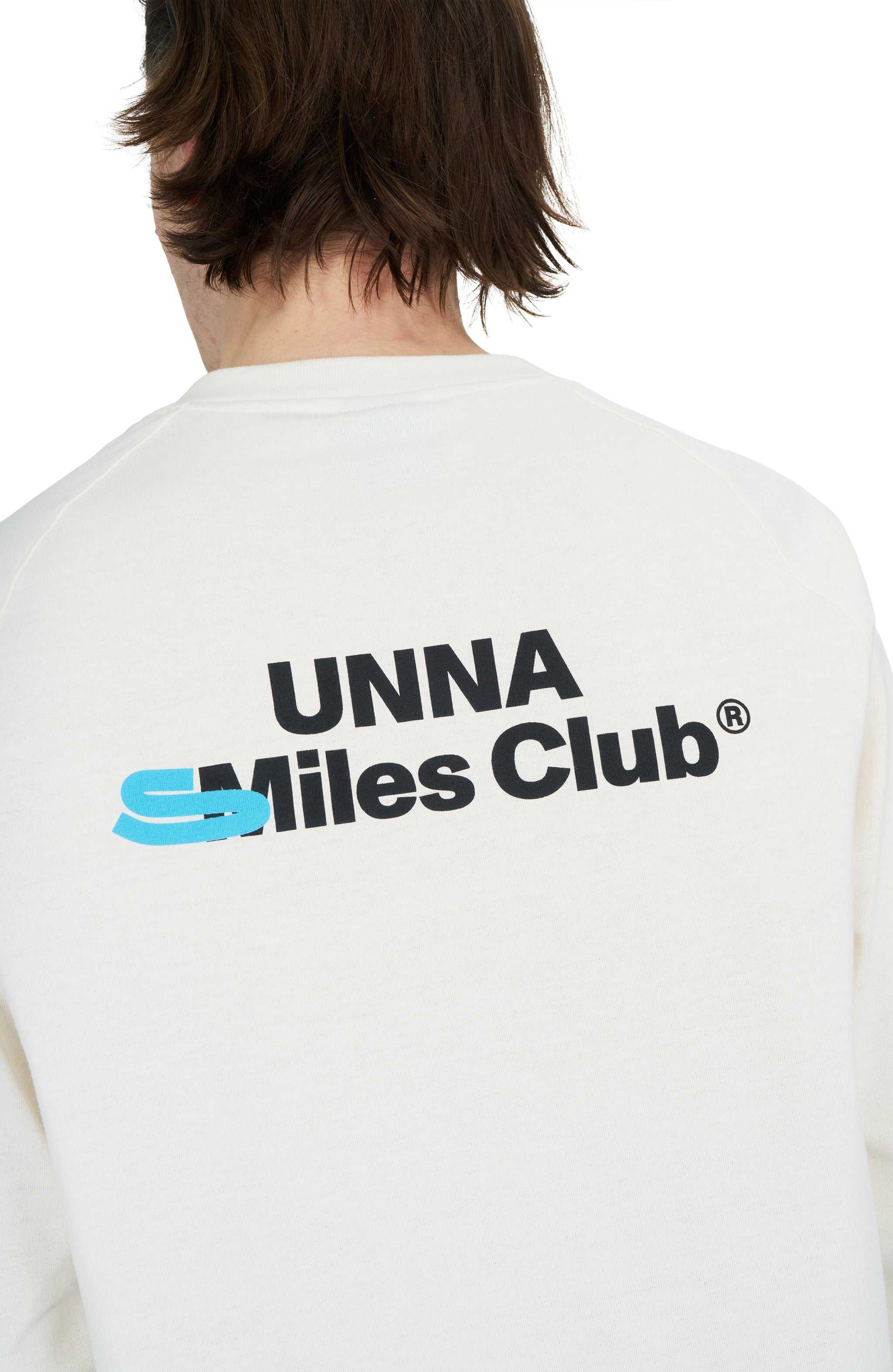 Men's Vanilla White long sleeve raglan T-shirt with UNNA Smiles Club print on back.