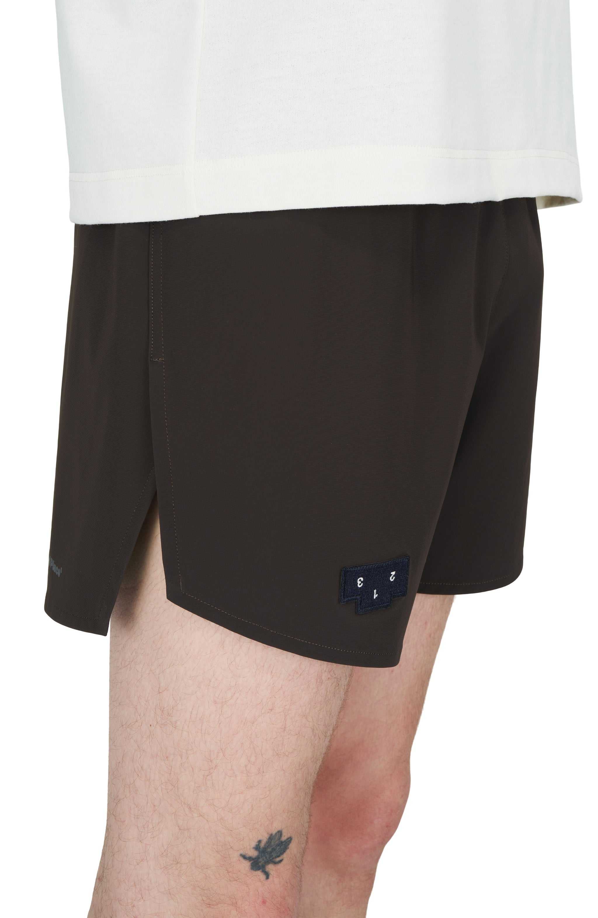 Men's Java Brown running shorts with side vents, reflective logo, and hidden pockets.