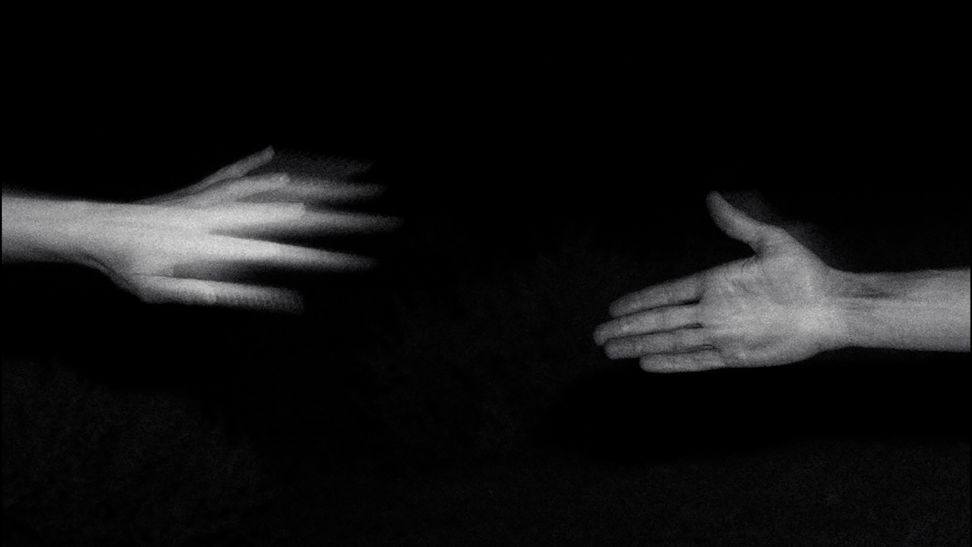 Two outstretched hands reaching toward each other in black and white representing connection and movement for Make Running product.