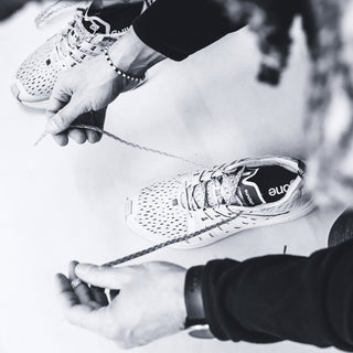 Running shoes being laced up, emphasizing comfort and style for Sunday runs.